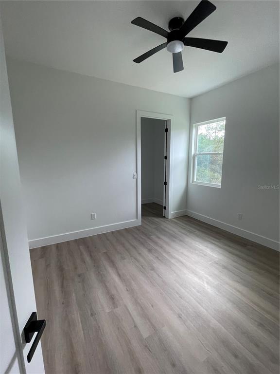 41719 Aspen Street Eustis, FL 32736 - Photo 43 of 52 wooden floor in an empty room with a window