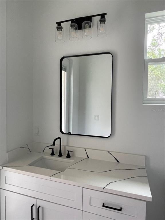 41719 Aspen Street Eustis, FL 32736 - Photo 45 of 52 a bathroom with a sink and a mirror