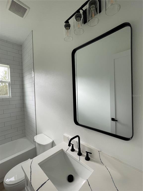 41719 Aspen Street Eustis, FL 32736 - Photo 50 of 52 a bathroom with a sink a toilet and shower