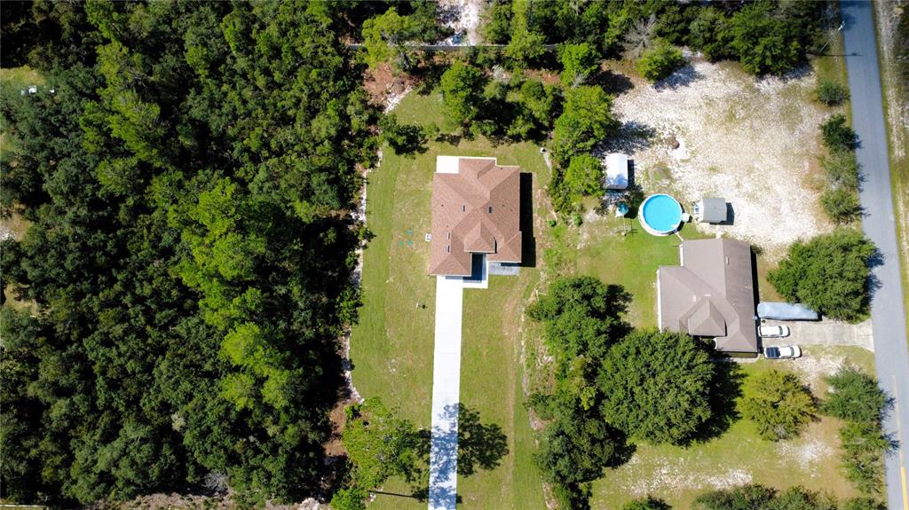 41719 Aspen Street Eustis, FL 32736 - Photo 5 of 52 an aerial view of a house with swimming pool and garden space