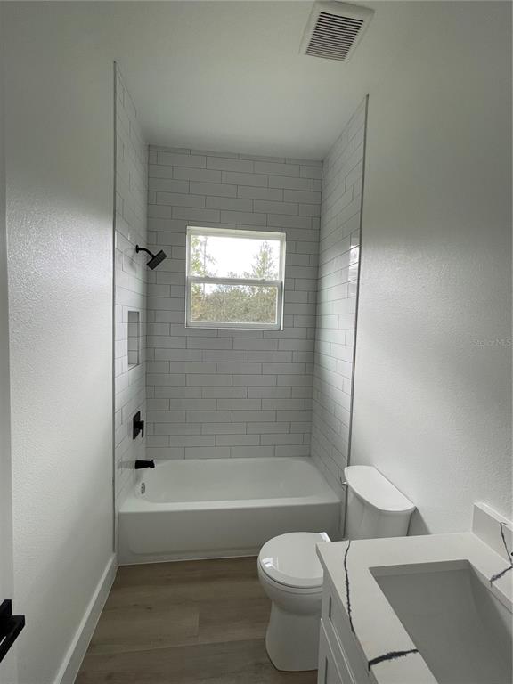 41719 Aspen Street Eustis, FL 32736 - Photo 51 of 52 a bathroom with a toilet and a bathtub