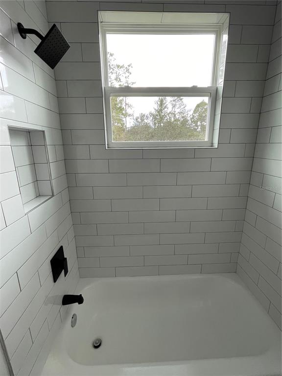 41719 Aspen Street Eustis, FL 32736 - Photo 52 of 52 a bathroom with a bathtub