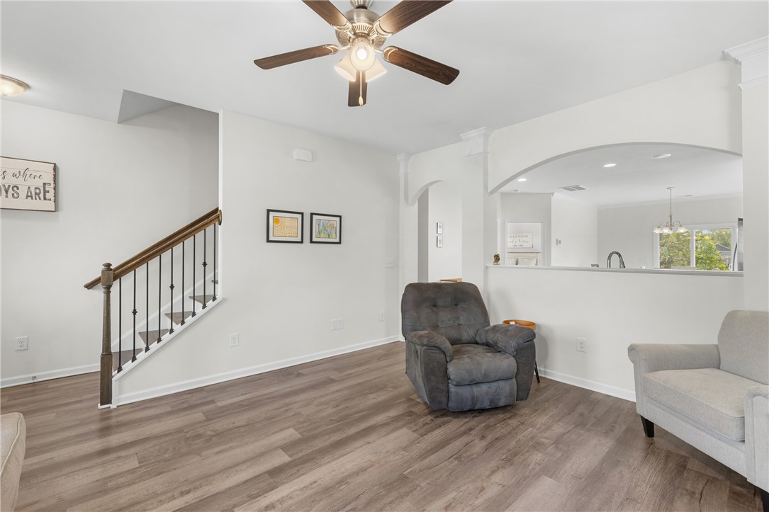 768 Rocky Ridge Circle Seneca, SC 29678 - Photo 8 of 30 An inviting interior with elegant hardwood flooring, showcasing a staircase and a pass-through to the kitchen.