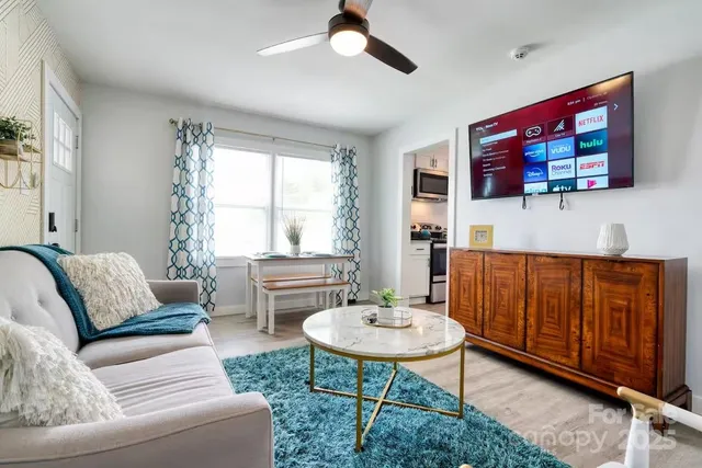 a living room with furniture and a wooden floor
