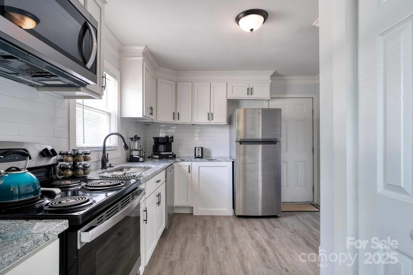 3337 Washburn Avenue Charlotte, NC 28205 - Photo 15 of 23 a kitchen with a sink appliances and cabinets