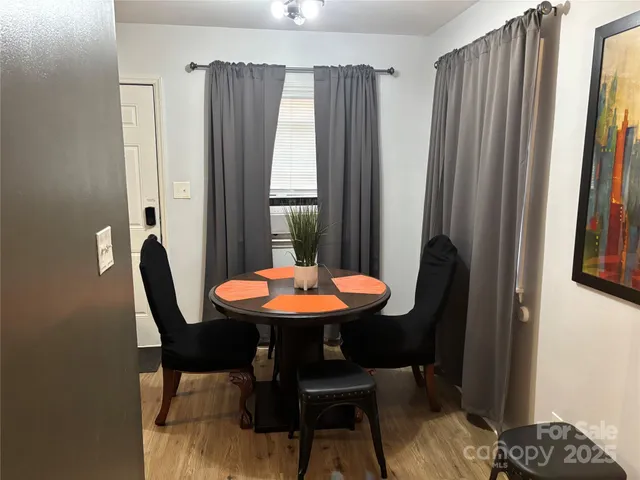 a view of a dining room with furniture and window