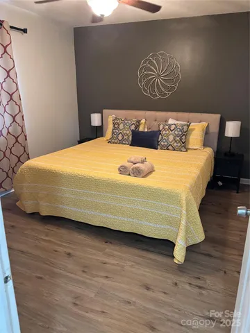 a bedroom with a bed and wooden floor