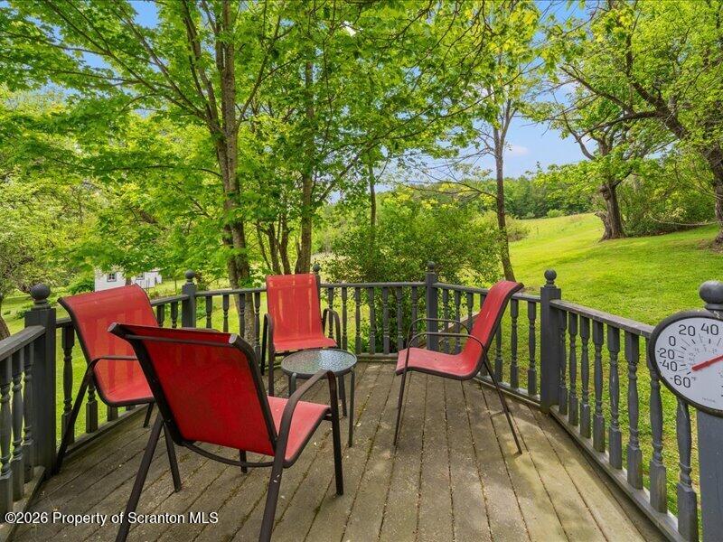 71 Pleasant Avenue Thompson, PA 18465 - Photo 28 of 37 an outdoor sitting area with furniture and wooden floor