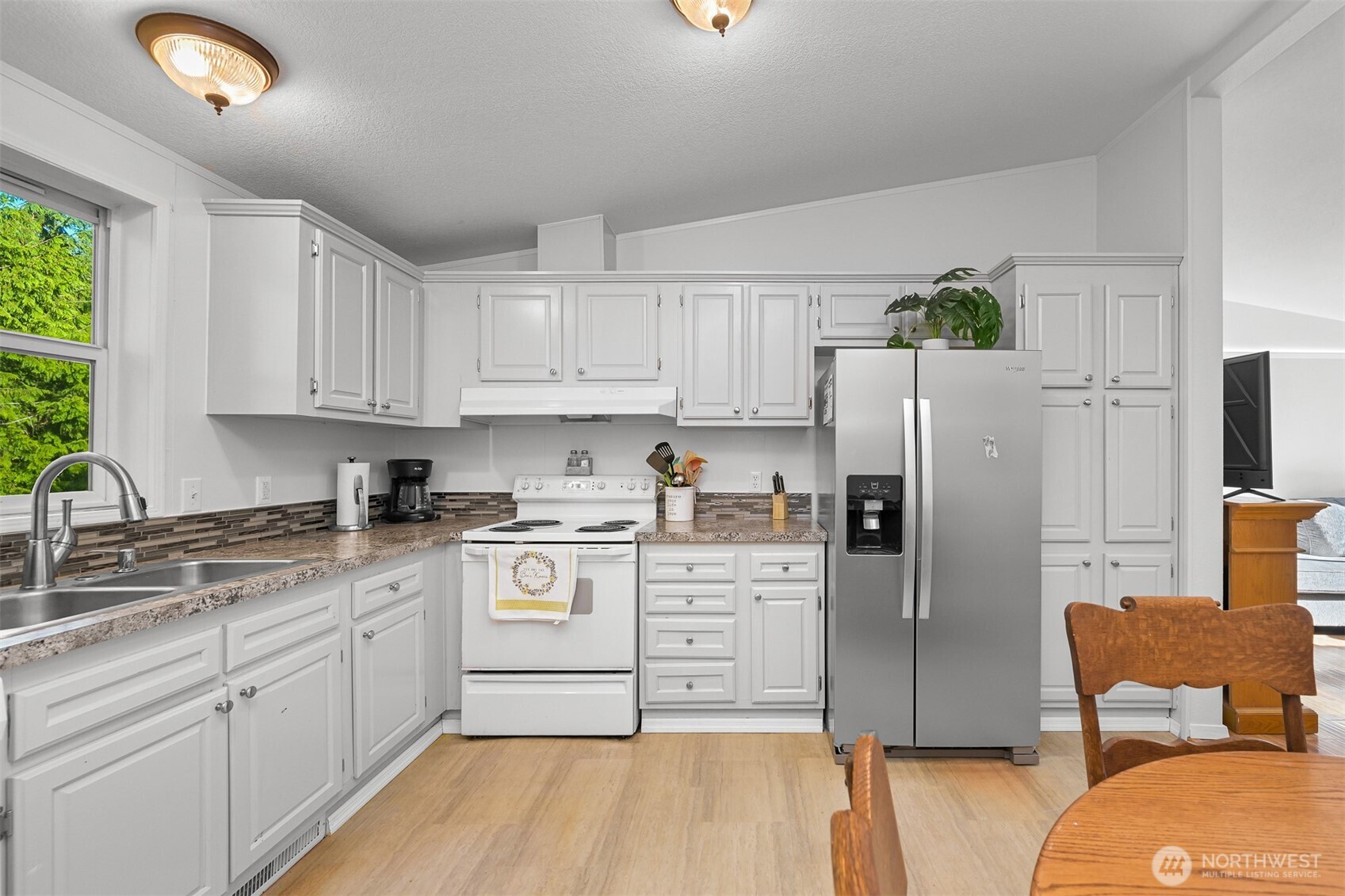 2174 Yew Street Road, Unit 22 Bellingham, WA 98229 - Photo 19 of 36 a kitchen with stainless steel appliances granite countertop a refrigerator sink and stove