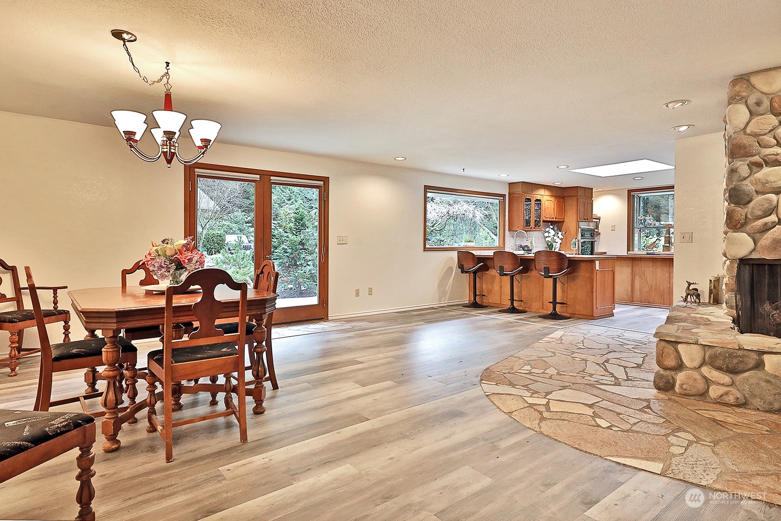 5003 East Harbor Road Freeland, WA 98249 - Photo 12 of 40 a view of a dining room with furniture a chandelier and wooden floor