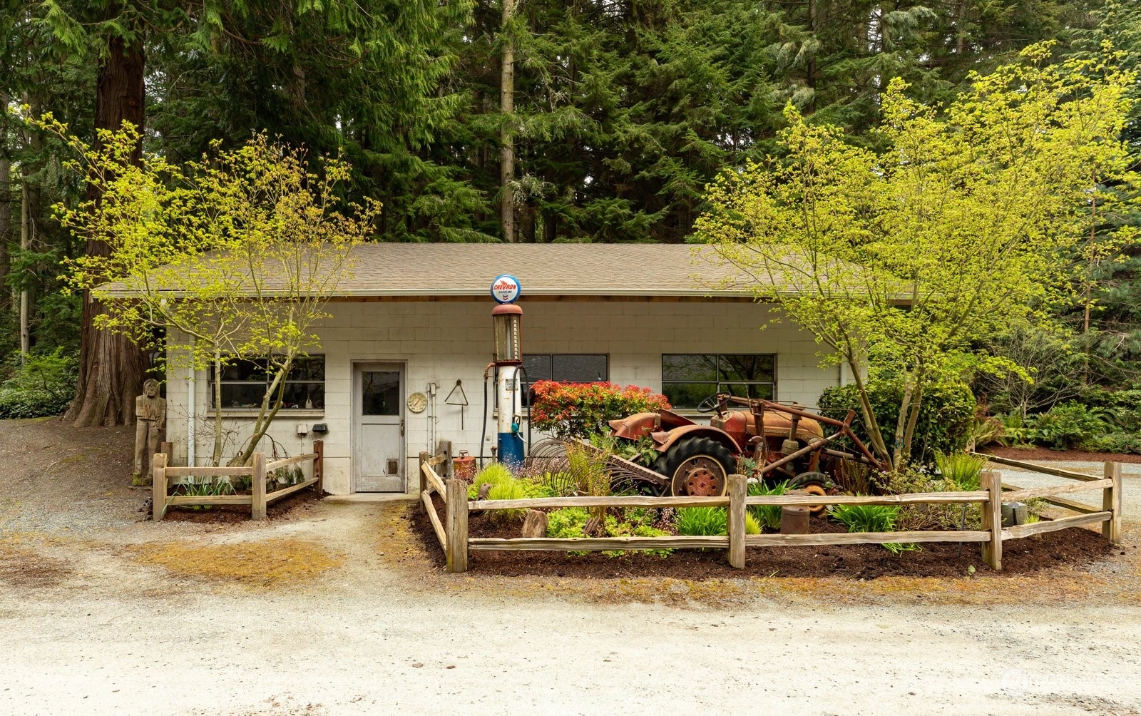 5003 East Harbor Road Freeland, WA 98249 - Photo 26 of 40 a view of a patio with table and chairs a barbeque and wooden fence