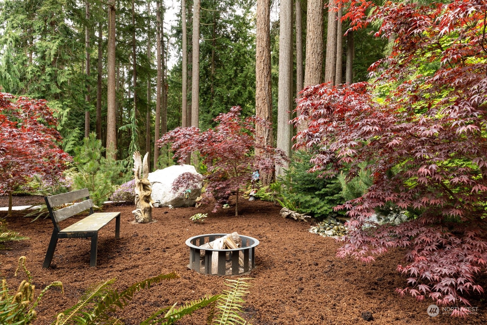 5003 East Harbor Road Freeland, WA 98249 - Photo 5 of 40 a view of a backyard with chair and potted plants