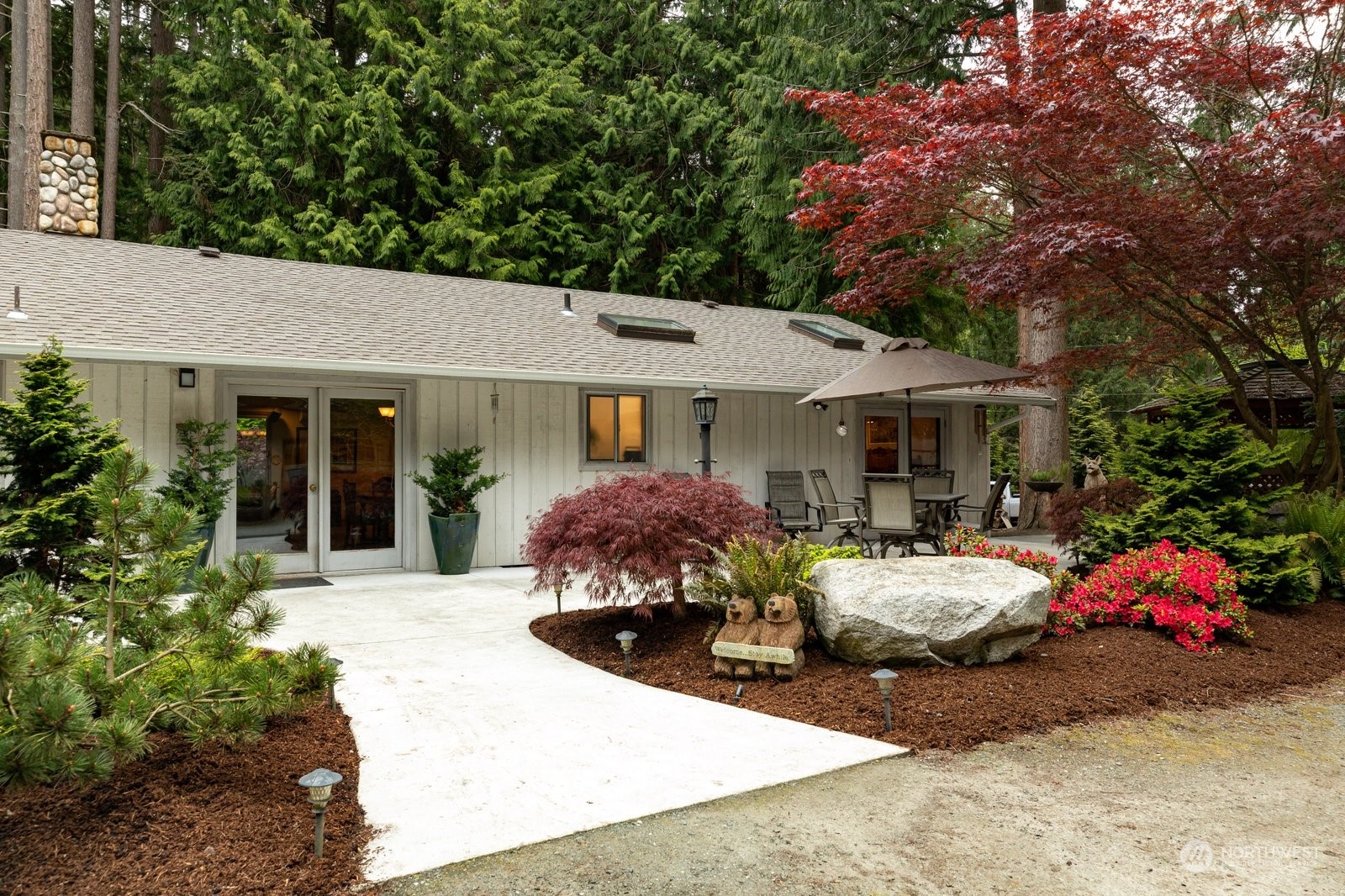 5003 East Harbor Road Freeland, WA 98249 - Photo 8 of 40 a front view of a house with a yard and garage