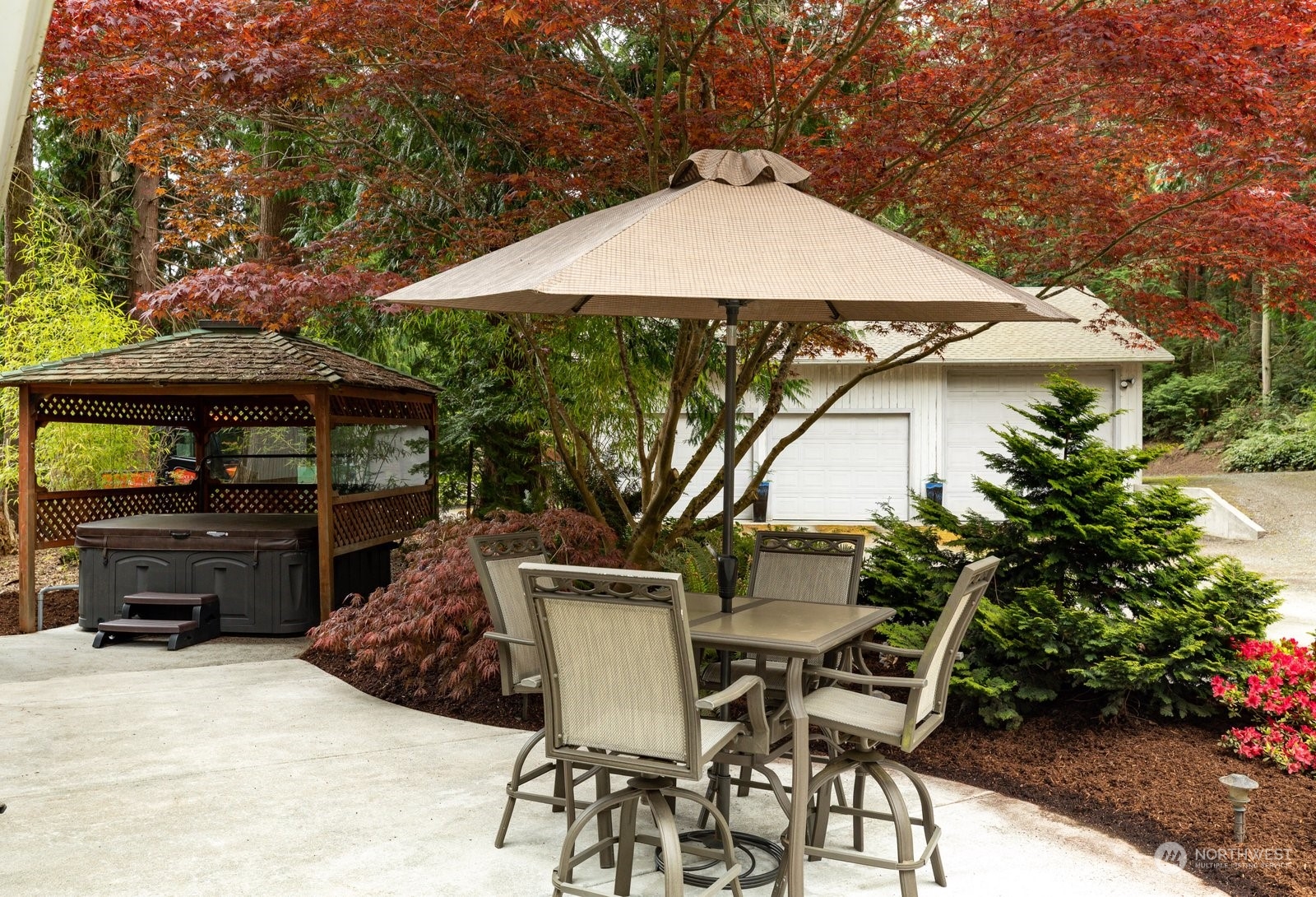 5003 East Harbor Road Freeland, WA 98249 - Photo 9 of 40 a patio with a table and chairs under an umbrella