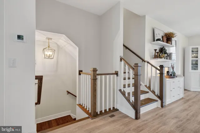 a large kitchen with stainless steel appliances granite countertop a sink a stove and a wooden floors