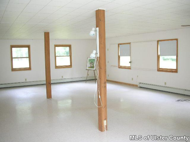 684 Sundown Road Grahamsville, NY 12740 - Photo 2 of 4 an empty room with windows