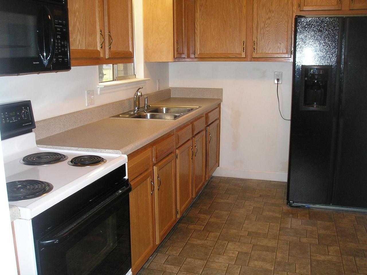 521 Holiday Road Vinton, VA 24179 - Photo 3 of 5 a kitchen with a sink stove and cabinets
