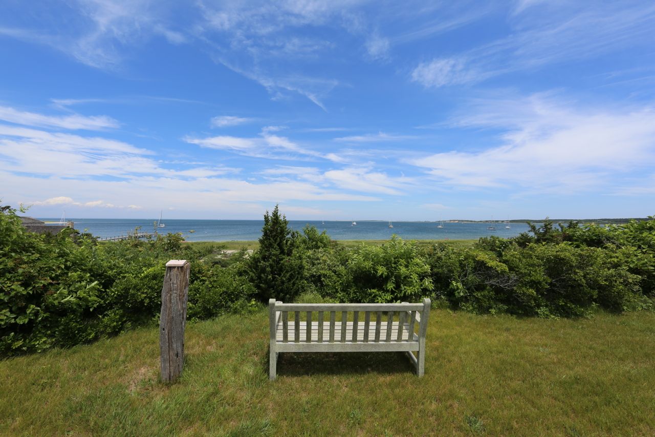8 Calebs Pond Road Edgartown, MA 02539 - Photo 2 of 49 a view of a garden with a building in the background