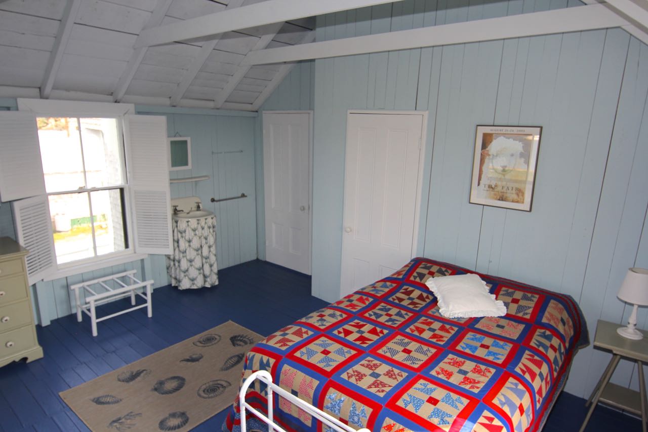 8 Calebs Pond Road Edgartown, MA 02539 - Photo 26 of 49 a bedroom with a bed and a window