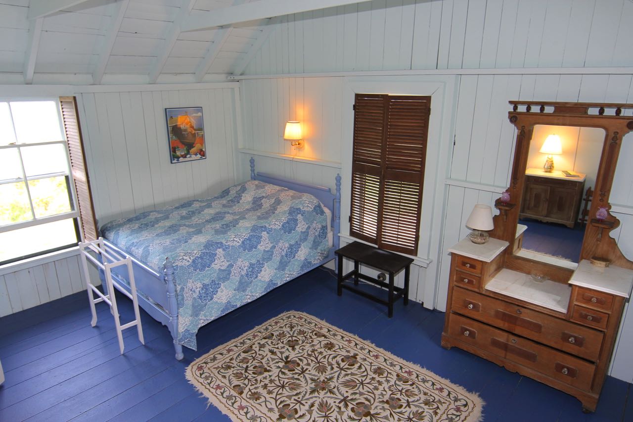 8 Calebs Pond Road Edgartown, MA 02539 - Photo 31 of 49 a bedroom with a bed and a dresser next to a window