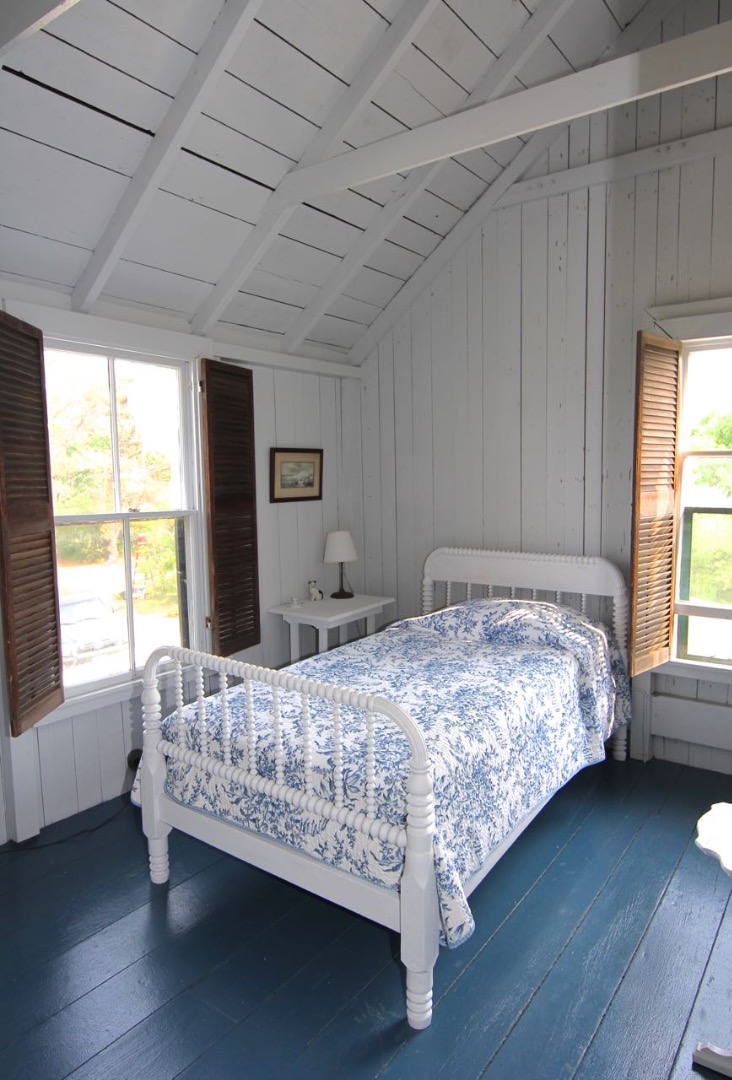 8 Calebs Pond Road Edgartown, MA 02539 - Photo 35 of 49 a bedroom with a bed wooden floor and window