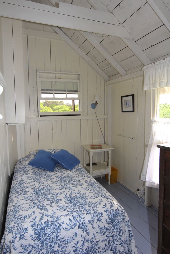 8 Calebs Pond Road Edgartown, MA 02539 - Photo 36 of 49 a bedroom with a bed and a window