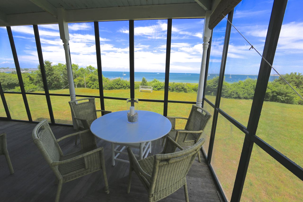8 Calebs Pond Road Edgartown, MA 02539 - Photo 6 of 49 a view of a city from a dining room with furniture and window