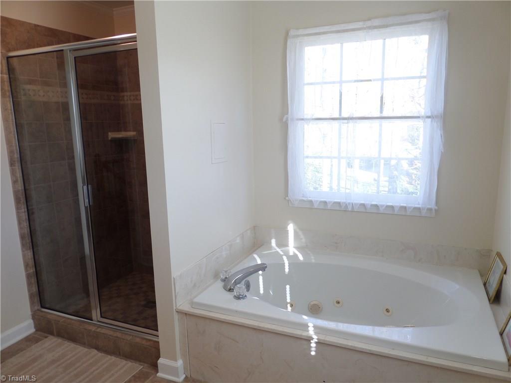 6325 Armsby Road Clemmons, NC 27012 - Photo 19 of 30 Jetted tub in the master bath with a window for natural lighting ... note the tiled separate shower to the left.