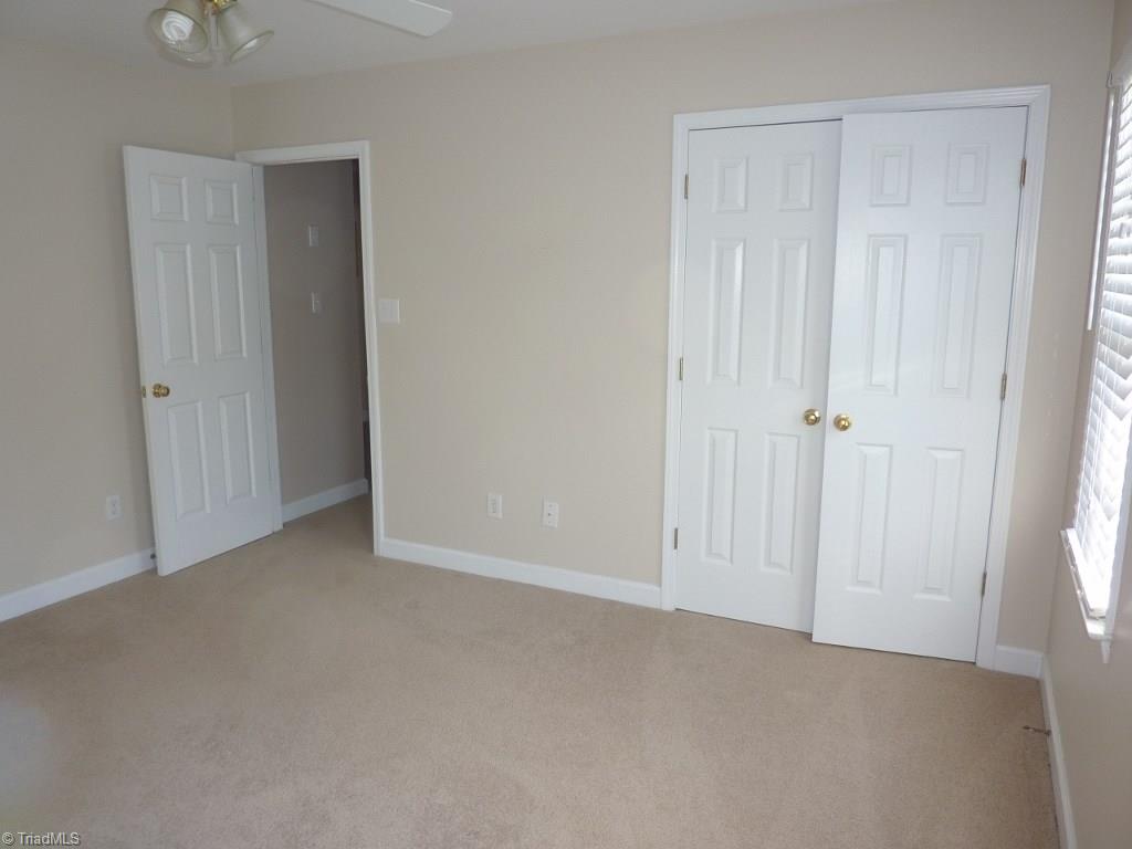 6325 Armsby Road Clemmons, NC 27012 - Photo 21 of 30 Second Bedroom with a double closet, ceiling fan, and neutral decor.