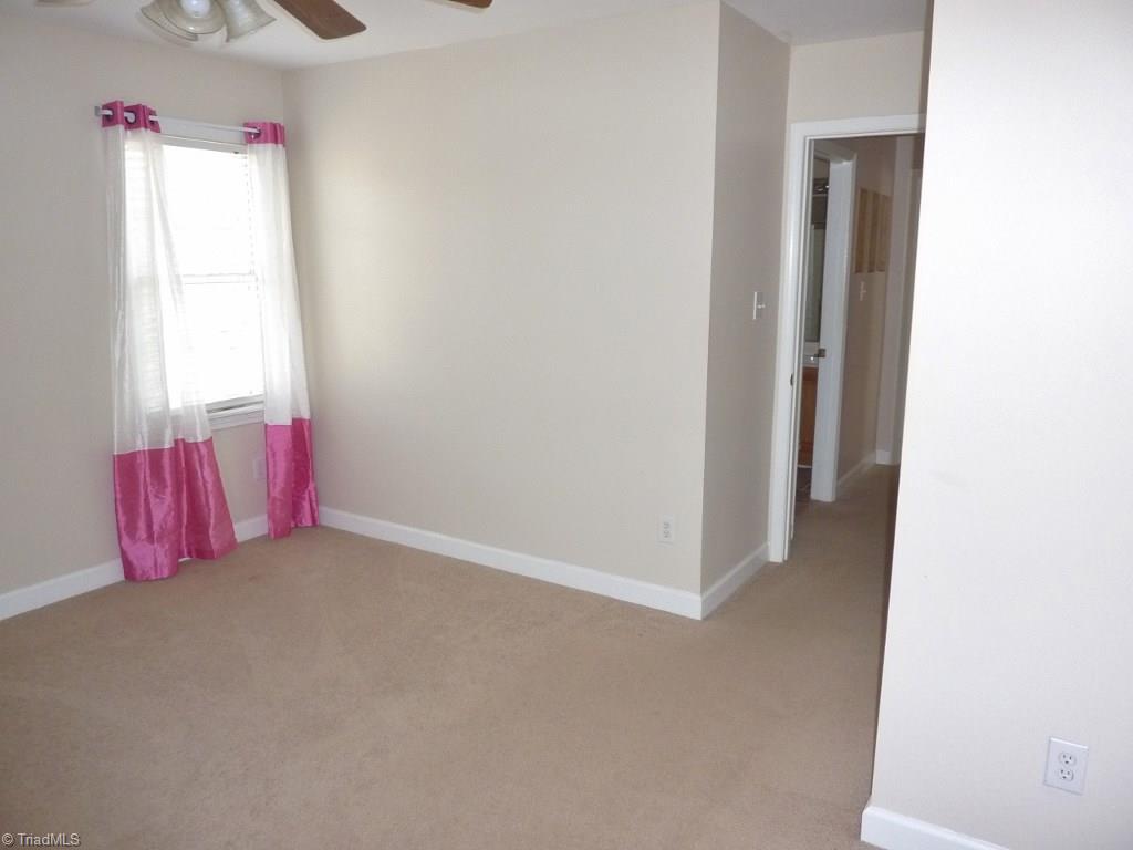 6325 Armsby Road Clemmons, NC 27012 - Photo 23 of 30 Third Bedroom with a ceiling fan, neutral decor, and convenient to the hall bath.