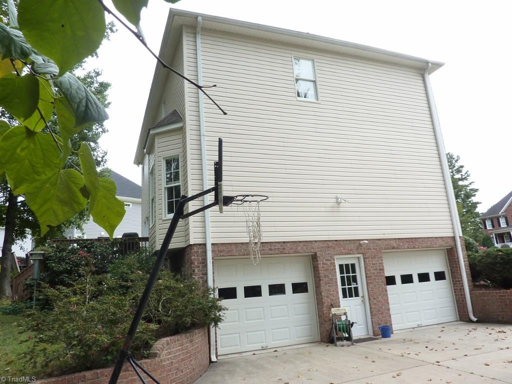 6325 Armsby Road Clemmons, NC 27012 - Photo 27 of 30 Large 2 car garage with garage door openers and a level parking area for guest parking .... storage room off the garage.