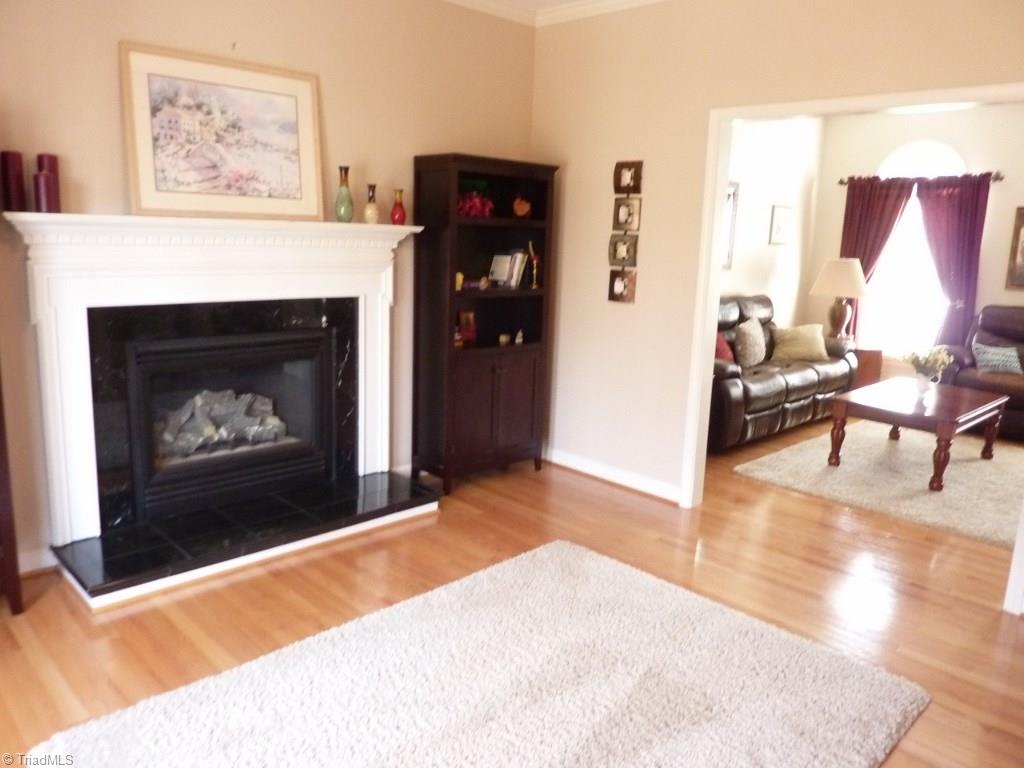6325 Armsby Road Clemmons, NC 27012 - Photo 6 of 30 Great Room with hardwoods, gas logs fireplace with a wide mantle and marble surround & hearth, wide entrance to the formal living room.