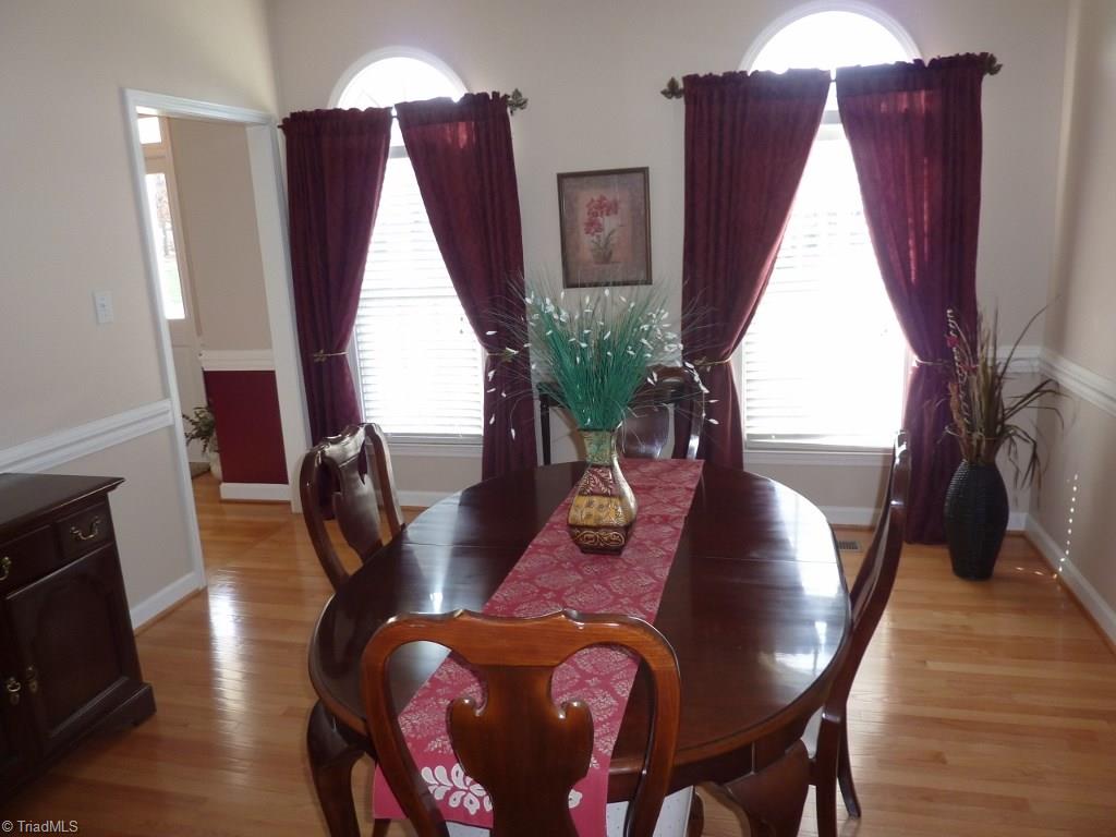 6325 Armsby Road Clemmons, NC 27012 - Photo 8 of 30 Formal Dining Room has hardwood flooring, atrium windows, and chair rail.