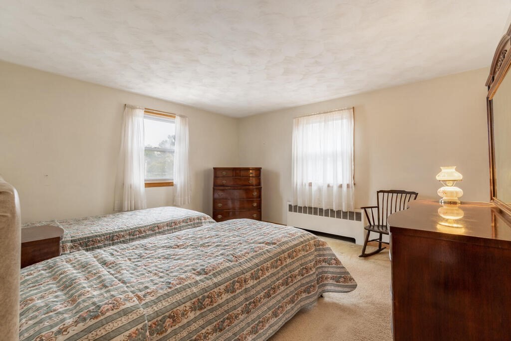 21 Roman Road Woburn, MA 01801 - Photo 11 of 29 a bedroom with a bed and a window