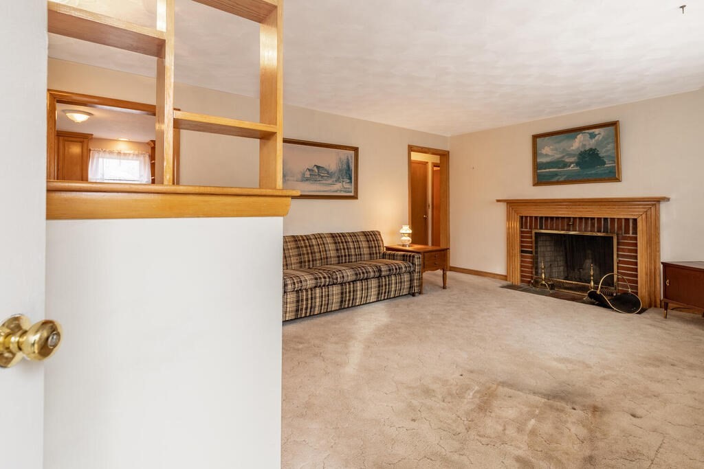 21 Roman Road Woburn, MA 01801 - Photo 17 of 29 a view of a livingroom with furniture and a fireplace