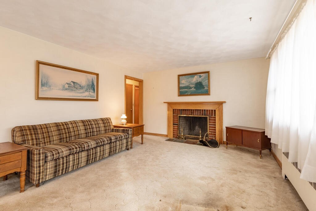 21 Roman Road Woburn, MA 01801 - Photo 18 of 29 a living room with furniture window and a fireplace