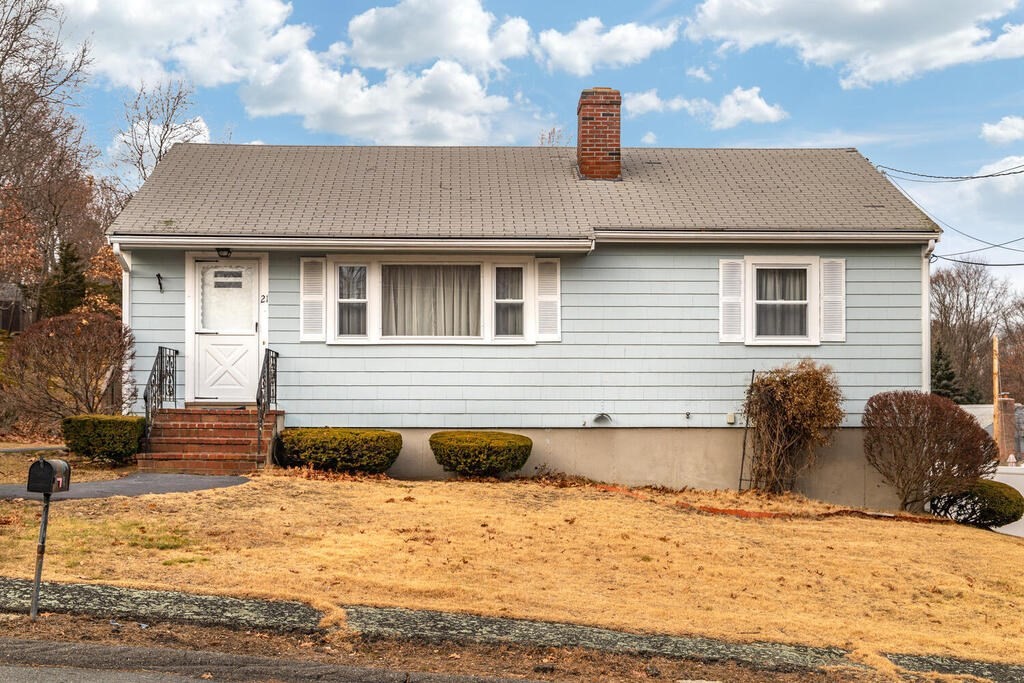 21 Roman Road Woburn, MA 01801 - Photo 5 of 29 a front view of a house with a yard