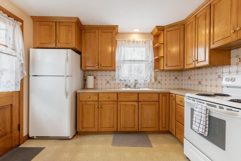 21 Roman Road Woburn, MA 01801 - Photo 8 of 29 a kitchen with granite countertop cabinets stainless steel appliances and a counter space
