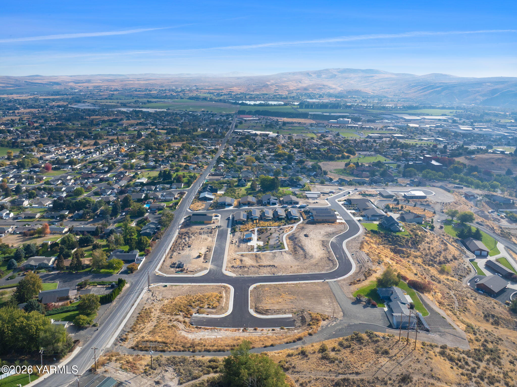 an aerial view of residential houses with outdoor space