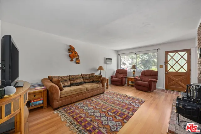 a living room with furniture ceiling fan and a rug