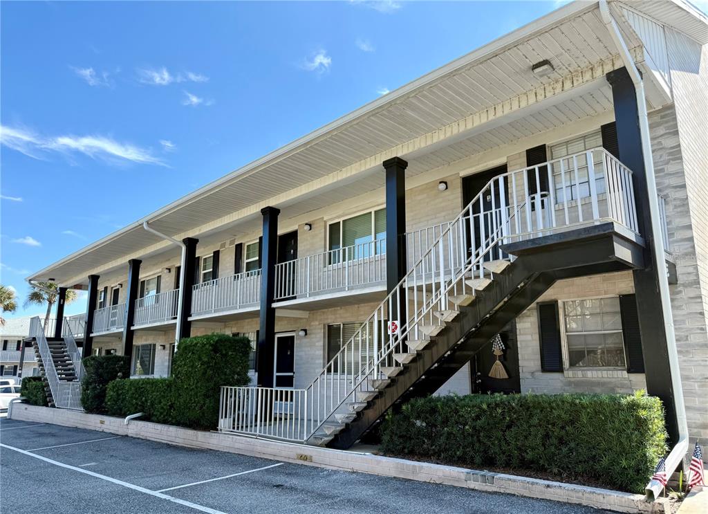 a front view of a building with a garden