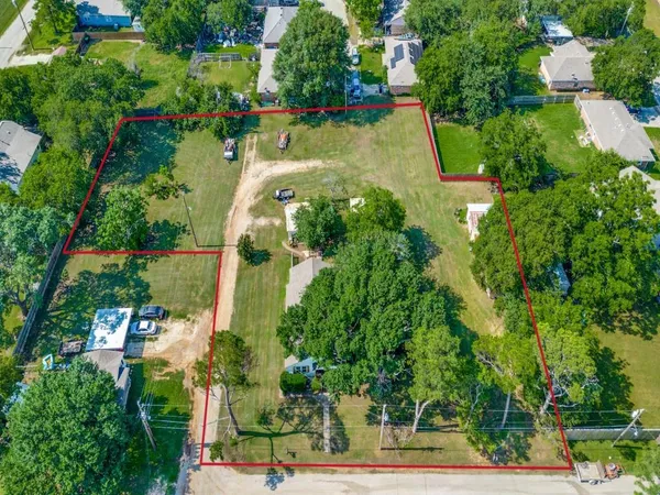 an aerial view of a house with a yard and lake view