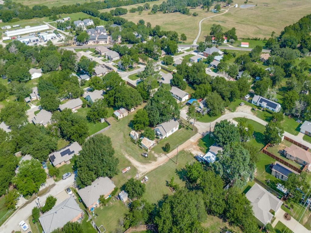 219 East Evans Street Pilot Point, TX 76258 - Photo 4 of 5 an aerial view of residential houses with outdoor space and trees
