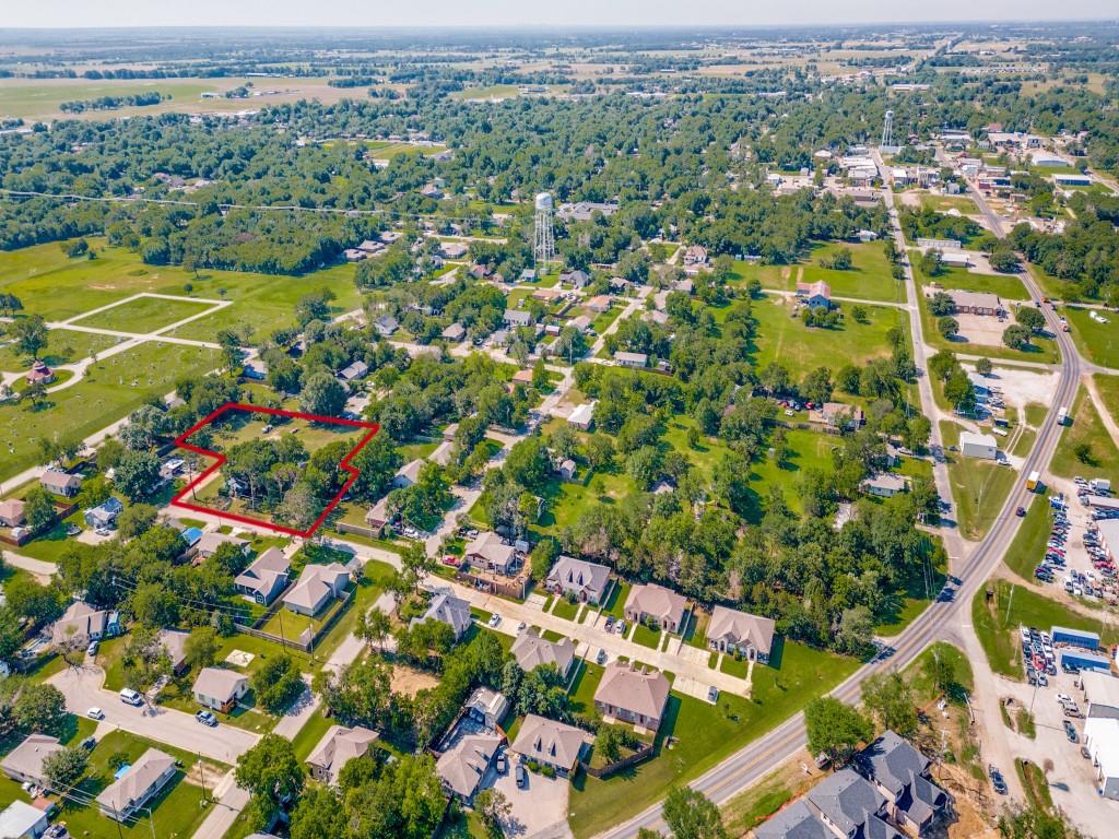 219 East Evans Street Pilot Point, TX 76258 - Photo 5 of 5 an aerial view of residential houses with outdoor space and parking