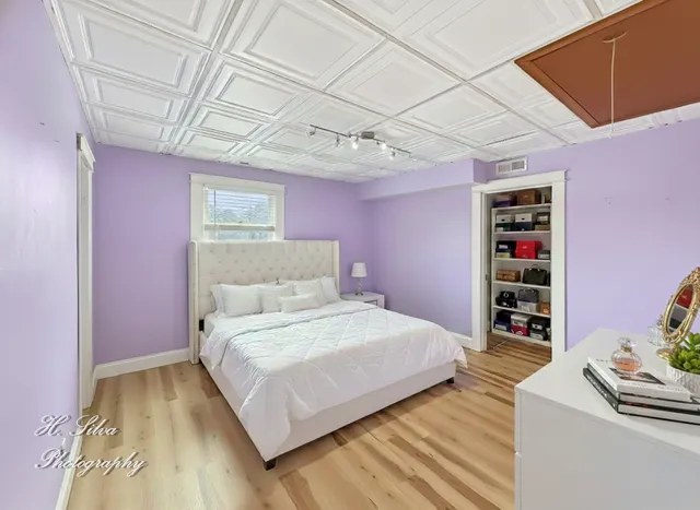 a bedroom with a bed and a window