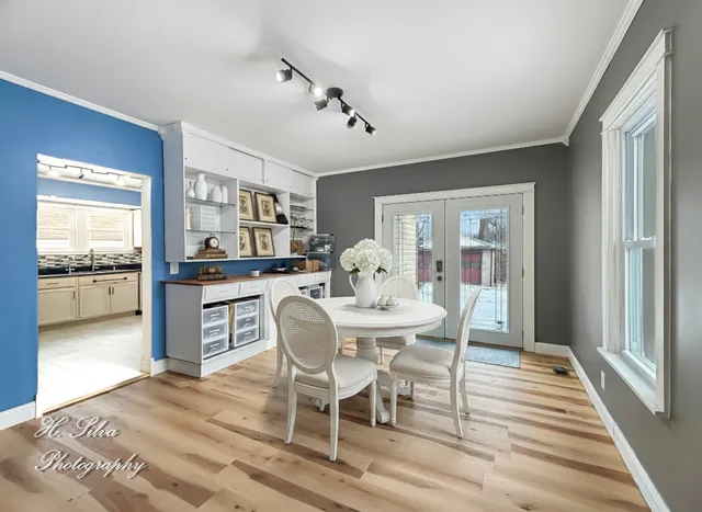 a view of a dining room with furniture window and wooden floor