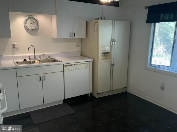 a kitchen with a sink cabinets and stainless steel appliances
