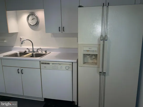 a kitchen with a sink and a refrigerator