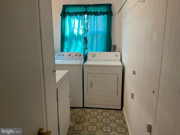 a view of bathroom with a washer and dryer