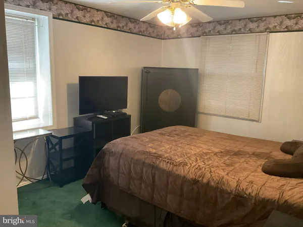 a bedroom with a bed and tv